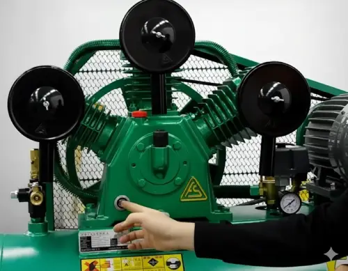 Technician using his hand to feel the air compressor pump head to ensure it has cooled down before starting maintenance work.